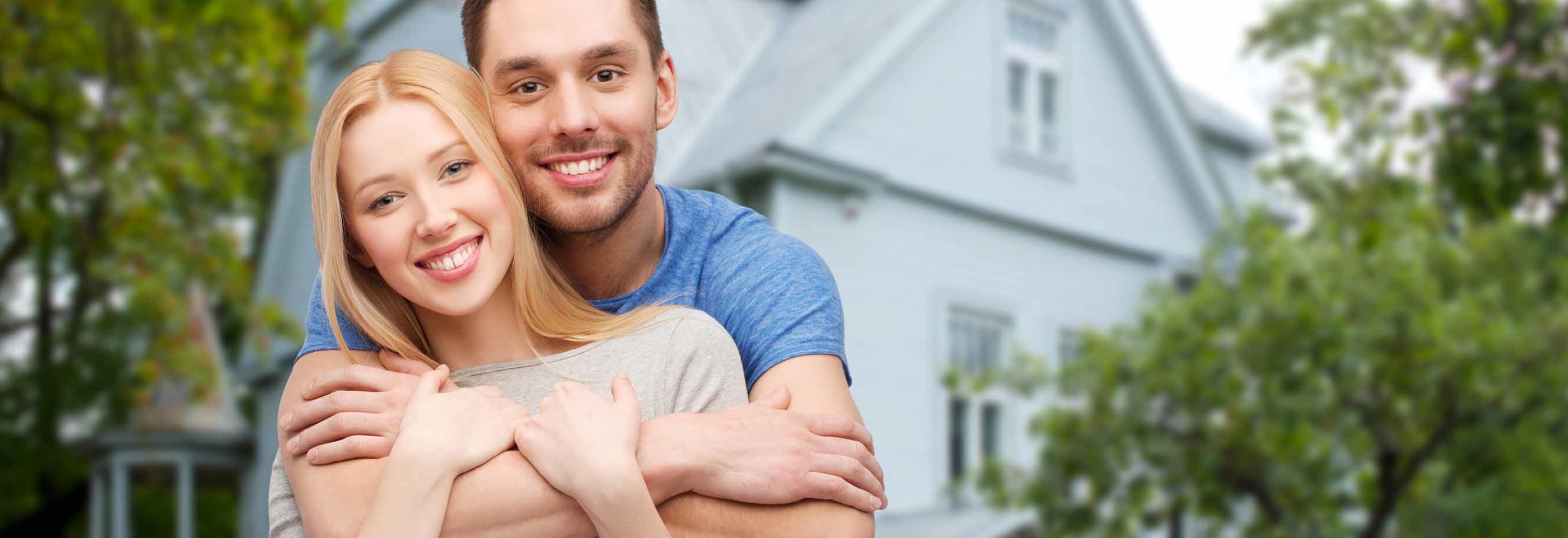 Image of couple in front of home